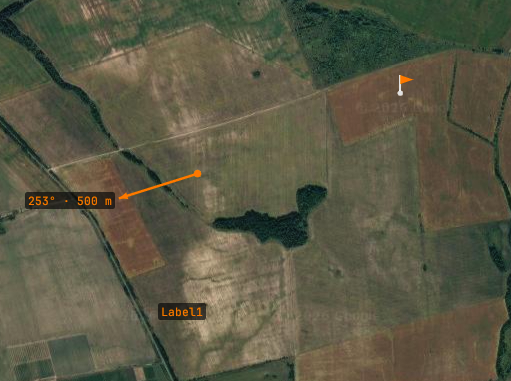Groundpost map with operator markers: a ground-length arrow labeled 253 degrees 500 meters, an orange flag, and a text label